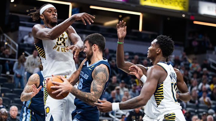 Oct 14, 2024; Indianapolis, Indiana, USA; Memphis Grizzlies forward GG Jackson II (45) rebounds the ball while Indiana Pacers center Myles Turner (33) defends in the first half at Gainbridge Fieldhouse. Mandatory Credit: Trevor Ruszkowski-Imagn Images
