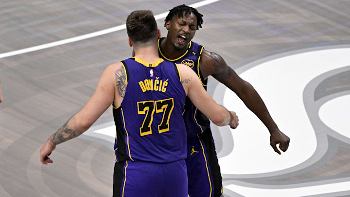 Apr 9, 2025; Dallas, Texas, USA; Los Angeles Lakers guard Luka Doncic (77) and forward Dorian Finney-Smith (17) celebrate during the fourth quarter against the Dallas Mavericks at the American Airlines Center. Mandatory Credit: Jerome Miron-Imagn Images