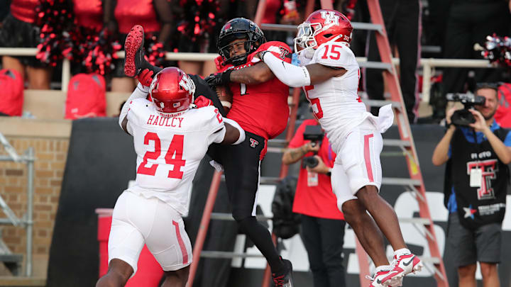 Sep 30, 2023; Lubbock, Texas, USA;  Texas Tech Red Raiders wide receiver Myles Price (1) catches a touchdown pass against Houston Cougars defensive back Malik Fleming (15) and defensive safety AJ Haulcy (24) in the second half at Jones AT&T Stadium and Cody Campbell Field. Mandatory Credit: Michael C. Johnson-Imagn Images
