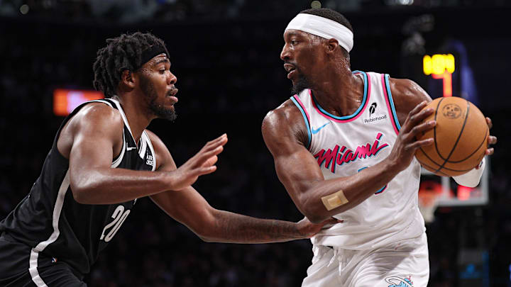 Feb 7, 2025; Brooklyn, New York, USA; Miami Heat center Bam Adebayo (13) shields the ball from Brooklyn Nets center Day'Ron Sharpe (20) during the second half at Barclays Center. Mandatory Credit: Vincent Carchietta-Imagn Images