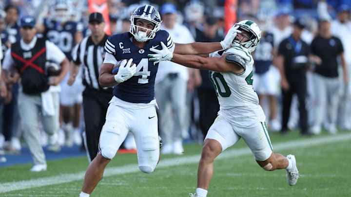 Aug 30, 2025; Provo, Utah, USA; Brigham Young Cougars running back LJ Martin (4) runs the ball against Portland State Vikings linebacker Lonnie Burt (40) during the second quarter at LaVell Edwards Stadium. Mandatory Credit: Rob Gray-Imagn Images