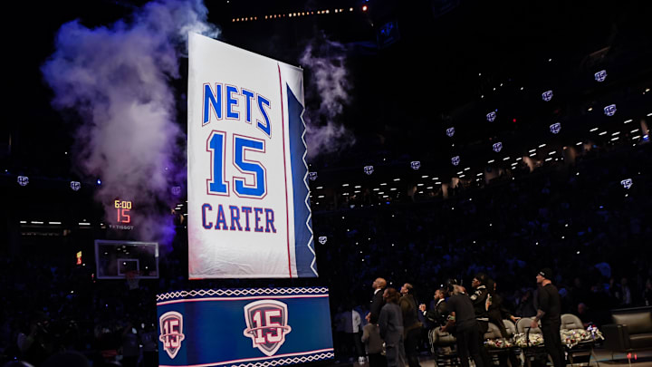Jan 25, 2025; Brooklyn, New York, USA; Former NBA star Vince Carter watches with family members as his number is raised to the rafters during his jersey retirement ceremony at halftime of a game between the Brooklyn Nets and the Miami Heat at Barclays Center. Mandatory Credit: John Jones-Imagn Images Jan 25, 2025; Brooklyn, New York, USA; Former NBA star Vince Carter watches with family members as his number is raised to the rafters during his jersey retirement ceremony at halftime of a game between the Brooklyn Nets and the Miami Heat at Barclays Center. Mandatory Credit: John Jones-Imagn Images