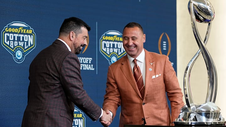 Ohio State Buckeyes head coach Ryan Day and Texas Longhorns head coach Steve Sarkisian shake hands following a press conference Ohio State Buckeyes head coach Ryan Day and Texas Longhorns head coach Steve Sarkisian shake hands following a press conference