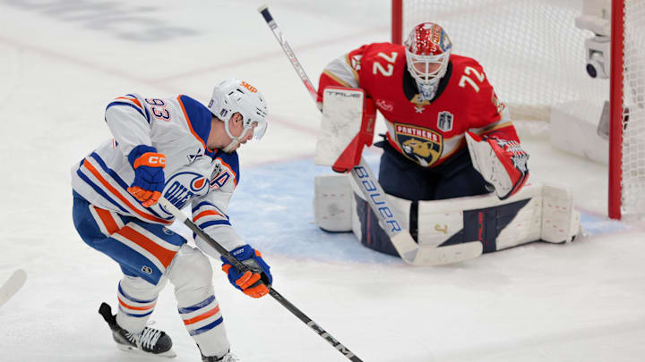 Jun 17, 2025; Sunrise, Florida, USA; Edmonton Oilers center Ryan Nugent-Hopkins (93) controls the puck as Florida Panthers goaltender Sergei Bobrovsky (72) defends the net during the second period in game six of the 2025 Stanley Cup Final at Amerant Bank Arena. Mandatory Credit: Sam Navarro-Imagn Images