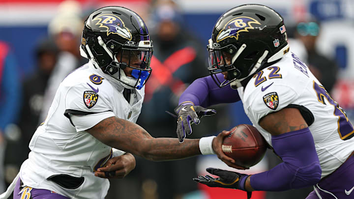 Dec 15, 2024; East Rutherford, New Jersey, USA; Baltimore Ravens quarterback Lamar Jackson (8) hands off to running back Derrick Henry (22) during the first quarter at MetLife Stadium. Mandatory Credit: Vincent Carchietta-Imagn Images