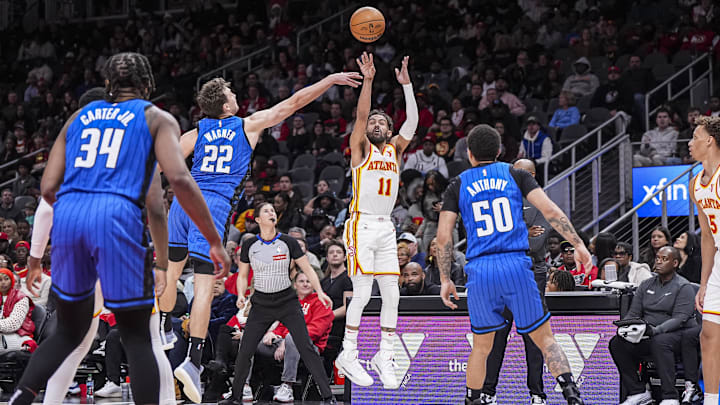 Atlanta Hawks guard Trae Young (11) shoots from the outside over Orlando Magic forward Franz Wagner (22) during the second half at State Farm Arena.