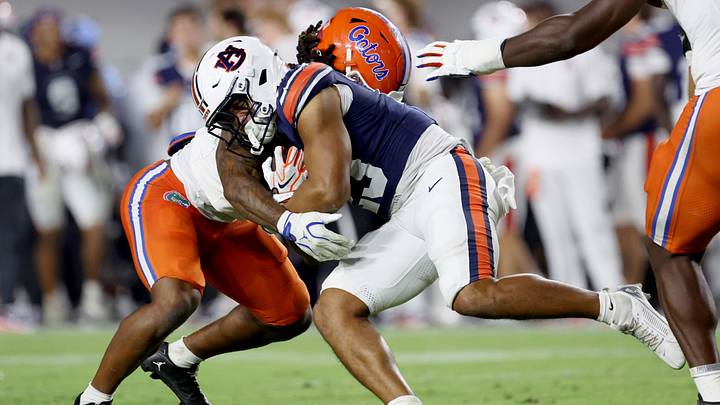 Sep 19, 2026; Auburn, Alabama, USA;  Florida Gators linebacker Myles Graham (5) tackles Auburn Tigers running back Jeremiah Cobb (23) during the third quarter at Jordan-Hare Stadium.  Mandatory Credit: John Reed-Imagn Images