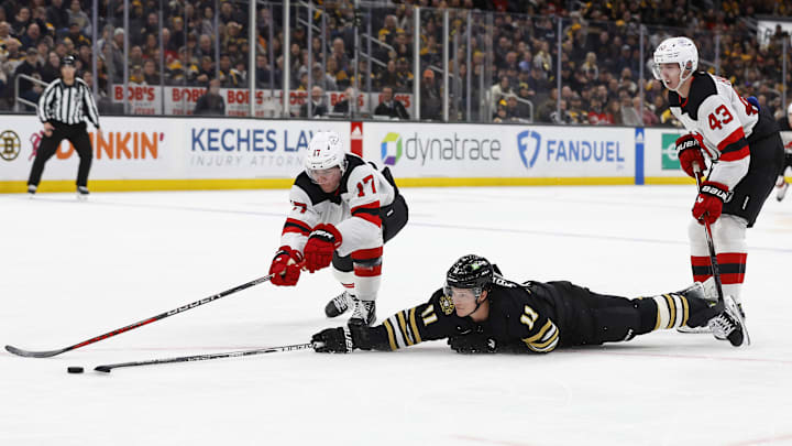 Jan 15, 2024; Boston, Massachusetts, USA; Boston Bruins center Trent Frederic (11) dives to poke a loose puck into the empty net past New Jersey Devils defenseman Simon Nemec (17) during the third period at TD Garden. Mandatory Credit: Winslow Townson-Imagn Images Jan 15, 2024; Boston, Massachusetts, USA; Boston Bruins center Trent Frederic (11) dives to poke a loose puck into the empty net past New Jersey Devils defenseman Simon Nemec (17) during the third period at TD Garden. Mandatory Credit: Winslow Townson-Imagn Images