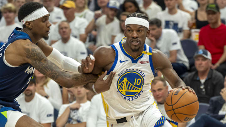 Golden State Warriors forward Jimmy Butler III (10) drives to the basket past Minnesota Timberwolves forward Jaden McDaniels (3) in the second half during game five of the second round for the 2025 NBA Playoffs at Target Center.
