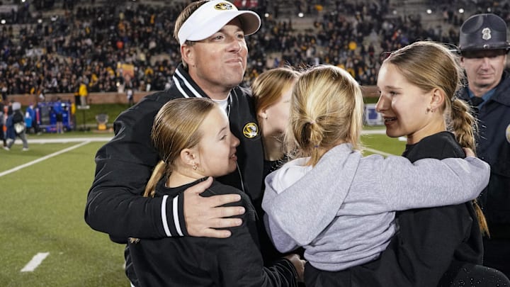 Nov 18, 2023; Columbia, Missouri, USA; Missouri Tigers head coach Eli Drinkwitz celebrates with his daughters after the win over the Florida Gators at Faurot Field at Memorial Stadium. Mandatory Credit: Denny Medley-Imagn Images Nov 18, 2023; Columbia, Missouri, USA; Missouri Tigers head coach Eli Drinkwitz celebrates with his daughters after the win over the Florida Gators at Faurot Field at Memorial Stadium. Mandatory Credit: Denny Medley-Imagn Images