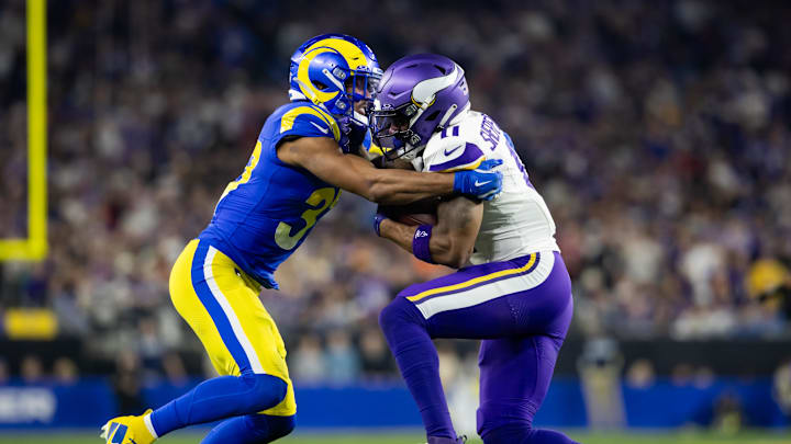 Jan 13, 2025; Glendale, AZ, USA; Los Angeles Rams safety Quentin Lake (37) tackles Minnesota Vikings wide receiver Trent Sherfield Sr. (11) during an NFC wild card game at State Farm Stadium. Mandatory Credit: Mark J. Rebilas-Imagn Images