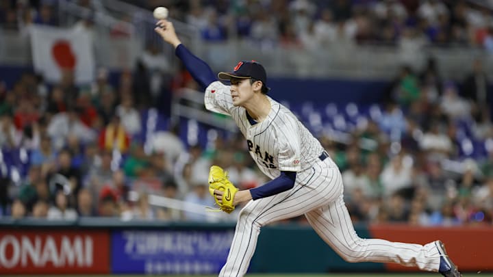 Mar 20, 2023; Miami, Florida, USA; Japan starting pitcher Roki Sasaki (14) delivers a pitch during the first inning against Mexico at LoanDepot Park. Mandatory Credit: Sam Navarro-Imagn Images