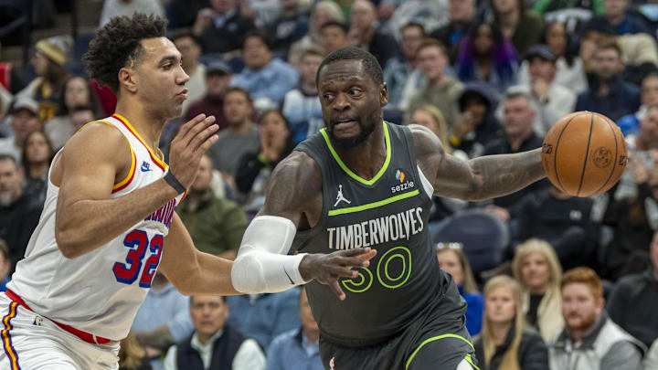 Minnesota Timberwolves forward Julius Randle dribbles the ball past Golden State Warriors forward Trayce Jackson-Davis in the first half at Target Center in Minneapolis on Jan. 15, 2025.