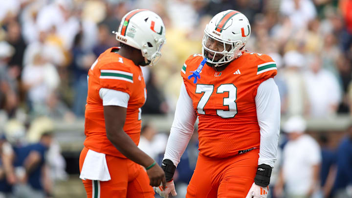 Nov 9, 2024; Atlanta, Georgia, USA; Miami Hurricanes quarterback Cam Ward (1) and offensive lineman Anez Cooper (73) celebrates after a touchdown against the Georgia Tech Yellow Jackets in the first quarter at Bobby Dodd Stadium at Hyundai Field. Mandatory Credit: Brett Davis-Imagn Images Nov 9, 2024; Atlanta, Georgia, USA; Miami Hurricanes quarterback Cam Ward (1) and offensive lineman Anez Cooper (73) celebrates after a touchdown against the Georgia Tech Yellow Jackets in the first quarter at Bobby Dodd Stadium at Hyundai Field. Mandatory Credit: Brett Davis-Imagn Images