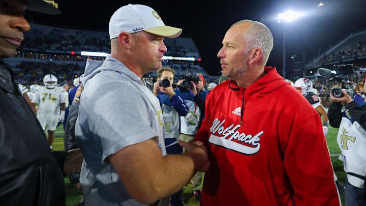 Nov 21, 2024; Atlanta, Georgia, USA; Georgia Tech Yellow Jackets head coach Brent Key talks to North Carolina State Wolfpack head coach Dave Doeren after a game at Bobby Dodd Stadium at Hyundai Field. Mandatory Credit: Brett Davis-Imagn Images
