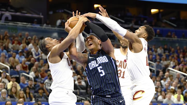 Orlando Magic forward Paolo Banchero (5) tries to get off a shot against the Cleveland Cavaliers during the first half at Kia Center.