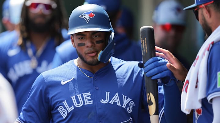 Mar 15, 2025; Jupiter, Florida, USA; Toronto Blue Jays shortstop Leo Jimenez (49) celebrates after scoring against the St. Louis Cardinals during the second inning at Roger Dean Chevrolet Stadium.