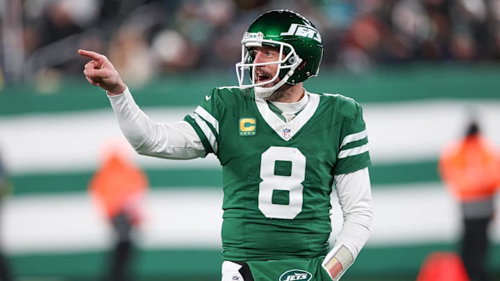 Jan 5, 2025; East Rutherford, New Jersey, USA; New York Jets quarterback Aaron Rodgers (8) gestures towards the Miami Dolphins bench during the second half at MetLife Stadium. Mandatory Credit: Vincent Carchietta-Imagn Images