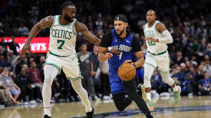Orlando Magic guard Jalen Suggs (4) drives to the basket past Boston Celtics guard Jaylen Brown (7) in the third quarter at Kia Center. Orlando Magic guard Jalen Suggs (4) drives to the basket past Boston Celtics guard Jaylen Brown (7) in the third quarter at Kia Center.