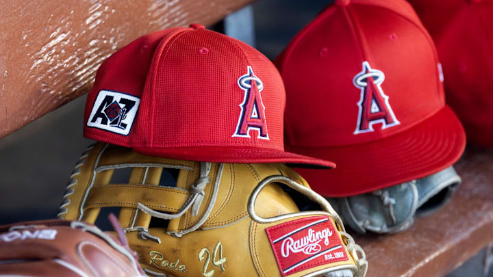 Feb 28, 2025; Phoenix, Arizona, USA; Detailed view of the Los Angeles Angels logo on a hat in the dugout during a spring training game at Camelback Ranch-Glendale. Mandatory Credit: Mark J. Rebilas-Imagn Images Feb 28, 2025; Phoenix, Arizona, USA; Detailed view of the Los Angeles Angels logo on a hat in the dugout during a spring training game at Camelback Ranch-Glendale. Mandatory Credit: Mark J. Rebilas-Imagn Images