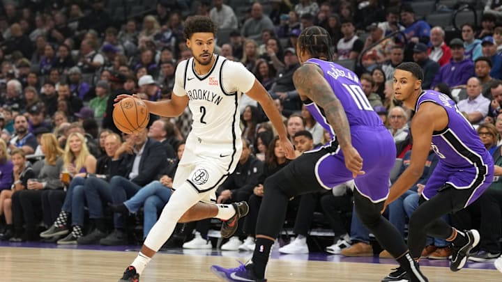 Nov 24, 2024; Sacramento, California, USA; Brooklyn Nets forward Cameron Johnson (2) dribbles against Sacramento Kings forwards DeMar DeRozan (10) and Keegan Murray (right) during the first quarter at Golden 1 Center. Mandatory Credit: Darren Yamashita-Imagn Images