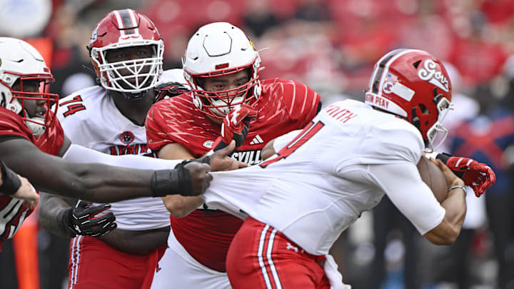Aug 31, 2024; Louisville, Kentucky, USA; Louisville Cardinals defensive lineman Thor Griffith (50) sacks Austin Peay Governors quarterback Austin Smith (4) during the second half at L&N Federal Credit Union Stadium. Louisville defeated Austin Peay 62-0.