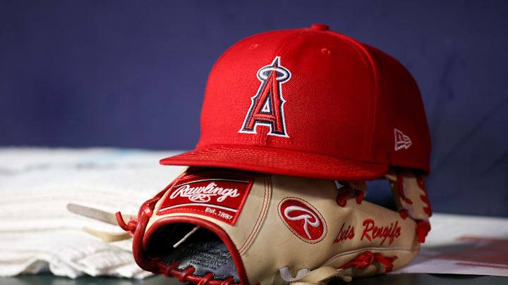 Aug 1, 2023; Atlanta, Georgia, USA; A detailed view of a Los Angeles Angels hat and glove on the bench against the Atlanta Braves in the eighth inning at Truist Park. Mandatory Credit: Brett Davis-Imagn Images