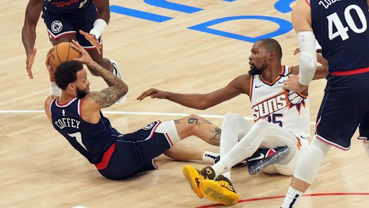 LA Clippers forward Amir Coffey (7) and Phoenix Suns forward Kevin Durant (35) battle for the ball in the first half at Intuit Dome. 