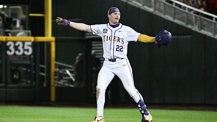Omaha, Neb, USA; LSU Tigers first baseman Jared Jones (22) celebrates driving in the winning run against the Arkansas Razorbacks during the ninth inning at Charles Schwab Field.