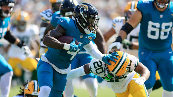 Jacksonville Jaguars running back Tank Bigsby (4) stiff arm Green Bay Packers safety Javon Bullard (20) during the second quarter of an NFL football matchup Sunday, Oct. 27, 2024 at EverBank Stadium in Jacksonville, Fla. [Corey Perrine/Florida Times-Union]