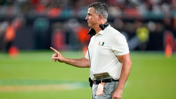 Nov 8, 2025; Miami Gardens, Florida, USA; Miami Hurricanes head coach Mario Cristobal gives his team instructions against the Syracuse Orange during the third quarter at Hard Rock Stadium. Mandatory Credit: Jeff Romance-Imagn Images