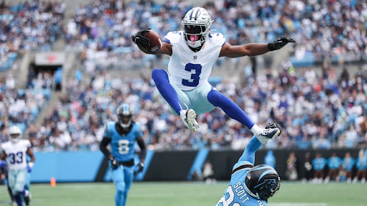 Dallas Cowboys wide receiver George Pickens jumps over Carolina Panthers safety Nick Scott at Bank of America Stadium Dallas Cowboys wide receiver George Pickens jumps over Carolina Panthers safety Nick Scott at Bank of America Stadium
