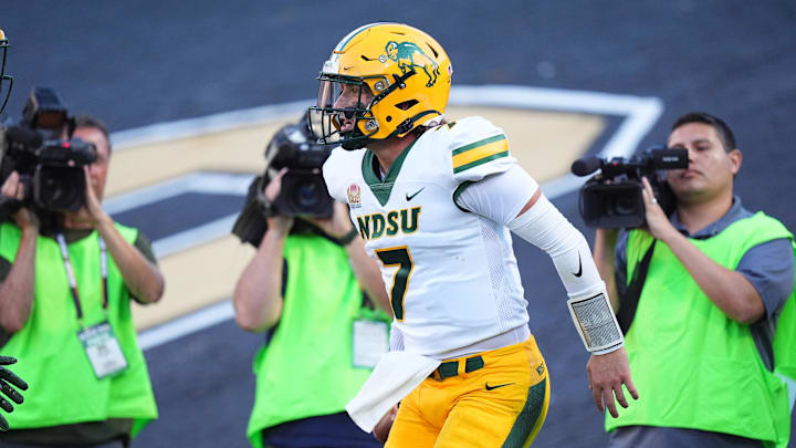 Aug 29, 2024; Boulder, Colorado, USA; North Dakota State Bison quarterback Cam Miller (7) celebrates his rushing touchdown in the second quarter against the Colorado Buffaloes at Folsom Field. Mandatory Credit: Ron Chenoy-Imagn Images