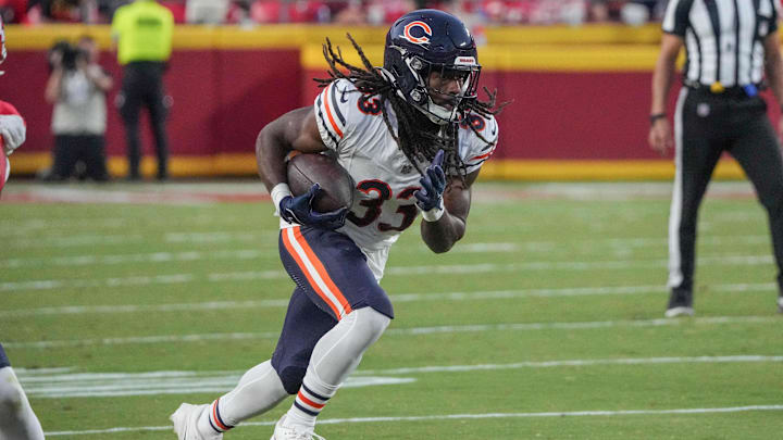 Aug 22, 2024; Kansas City, Missouri, USA; Chicago Bears running back Ian Wheeler (33) runs the ball against the Kansas City Chiefs during the game at GEHA Field at Arrowhead Stadium.