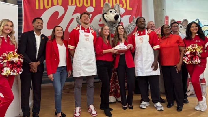 Jack Cochrane, Nick Bolton and others celebrate $1 million donation to Ronald McDonald House from annual Red Friday flag sales. 