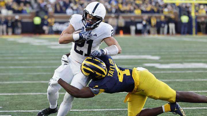Oct 17, 2026; Ann Arbor, Michigan, USA; Penn State Nittany Lions running back Carson Hansen (21) runs the ball pressured by Michigan Wolverines linebacker Chase Taylor (4) at Michigan Stadium. Mandatory Credit: Rick Osentoski-Imagn Images Oct 17, 2026; Ann Arbor, Michigan, USA; Penn State Nittany Lions running back Carson Hansen (21) runs the ball pressured by Michigan Wolverines linebacker Chase Taylor (4) at Michigan Stadium. Mandatory Credit: Rick Osentoski-Imagn Images