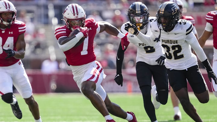 Oct 5, 2024; Madison, Wisconsin, USA;  Wisconsin Badgers running back Dilin Jones (7) rushes with the football after catching a pass during the fourth quarter against the Purdue Boilermakers at Camp Randall Stadium. Mandatory Credit: Jeff Hanisch-Imagn Images