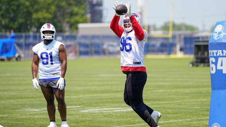 Buffalo Bills DT Deone Walker makes a catch with DT Ed Oliver (91) looking on during Minicamp at Highmark Stadium. Buffalo Bills DT Deone Walker makes a catch with DT Ed Oliver (91) looking on during Minicamp at Highmark Stadium.