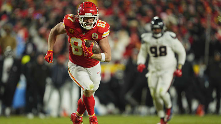 Jan 18, 2025; Kansas City, Missouri, USA; Kansas City Chiefs tight end Travis Kelce (87) runs the ball after a pass reception against the Houston Texans during the fourth quarter of a 2025 AFC divisional round game at GEHA Field at Arrowhead Stadium. Mandatory Credit: Jay Biggerstaff-Imagn Images