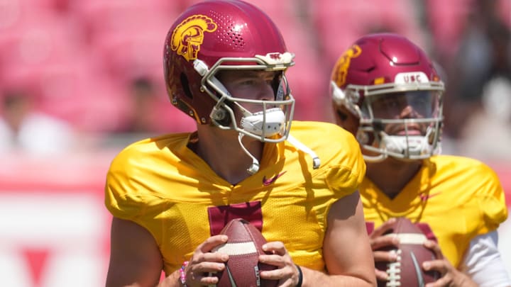 Former USC quarterbacks Miller Moss (7) and Caleb Williams (13) throw during warmups before the spring game.