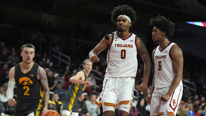 Jan 14, 2025; Los Angeles, California, USA; Southern California Trojans forward Saint Thomas (0) and guard Wesley Yates III (6) and Iowa Hawkeyes guard Brock Harding (2) react in the second half at the Galen Center. Mandatory Credit: Kirby Lee-Imagn Images