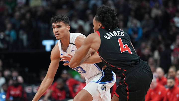 Orlando Magic forward Tristan da Silva (23) dribbles against Toronto Raptors forward Scottie Barnes (4) during the first quarter at Scotiabank Arena.