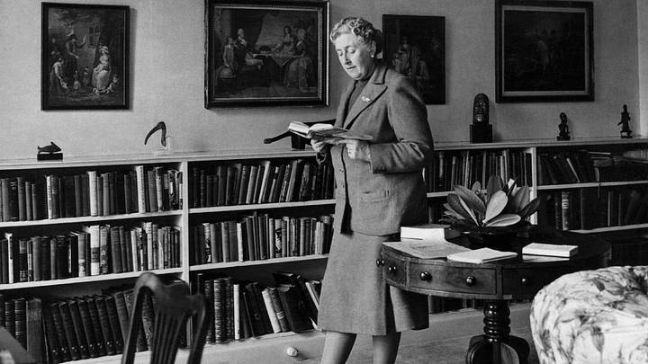 Agatha Christie reading in her library.