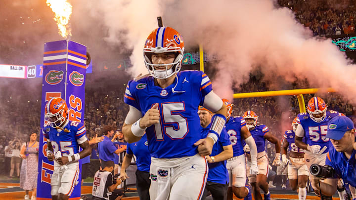 Florida Gators quarterback Graham Mertz (15) runs out of the tunnel with the team as fireworks and fire shoot out of towers before the start of the game at Ben Hill Griffin Stadium in Gainesville, FL on Saturday, October 5, 2024. [Doug Engle/Gainesville Sun]