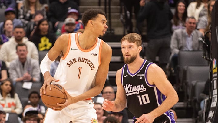 Feb 22, 2024; Sacramento, California, USA; San Antonio Spurs center Victor Wembanyama (1) controls the ball against Sacramento Kings forward Domantas Sabonis (10) during the first quarter at Golden 1 Center. Mandatory Credit: Ed Szczepanski-Imagn Images