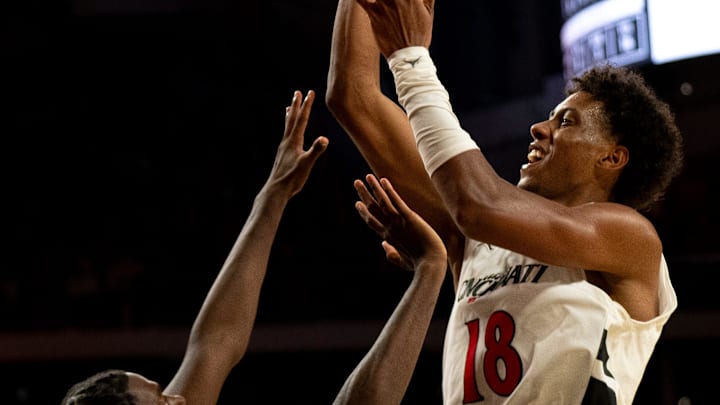 Cincinnati Bearcats forward Baba Miller (18) hits a shot and draws a foul from Georgia State Panthers forward Joah Chappelle (6) in the second half of the NCAA basketball game at Fifth Third Arena in Cincinnati on Nov. 7, 2025.
