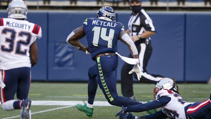 Sep 20, 2020; Seattle, Washington, USA; Seattle Seahawks wide receiver DK Metcalf (14) breaks a tackle against the New England Patriots for a touchdown catch during the second quarter at CenturyLink Field. Sep 20, 2020; Seattle, Washington, USA; Seattle Seahawks wide receiver DK Metcalf (14) breaks a tackle against the New England Patriots for a touchdown catch during the second quarter at CenturyLink Field.