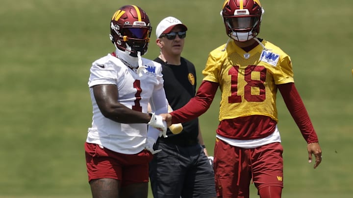 Washington Commanders WR Deebo Samuel Sr. shakes hands with Commanders QB Marcus Mariota between drills on day one of minicamp at Commanders Park.