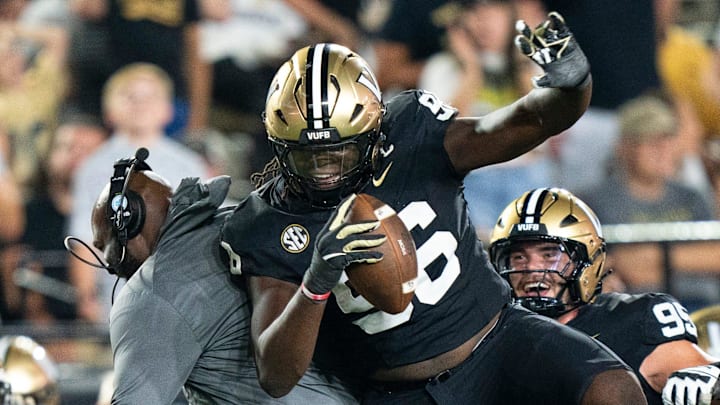 Vanderbilt defensive line coach Larry Black and Vanderbilt defensive lineman Khordae Sydnor (96) celebrate Sydnor's second-half fumble recovery during their game at FirstBank Stadium in Nashville, Tenn., 