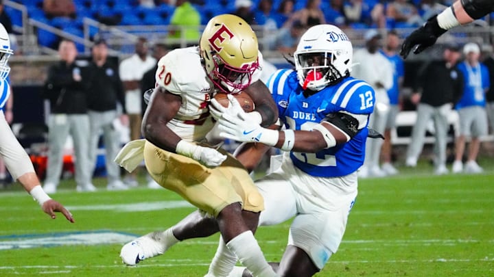 Aug 30, 2024; Durham, North Carolina, USA; Elon Phoenix running back TJ Thomas Jr. (20) is stopped on his run by Duke Blue Devils linebacker Tre Freeman (12) during the second half at Wallace Wade Stadium. Mandatory Credit: James Guillory-Imagn Images Aug 30, 2024; Durham, North Carolina, USA; Elon Phoenix running back TJ Thomas Jr. (20) is stopped on his run by Duke Blue Devils linebacker Tre Freeman (12) during the second half at Wallace Wade Stadium. Mandatory Credit: James Guillory-Imagn Images